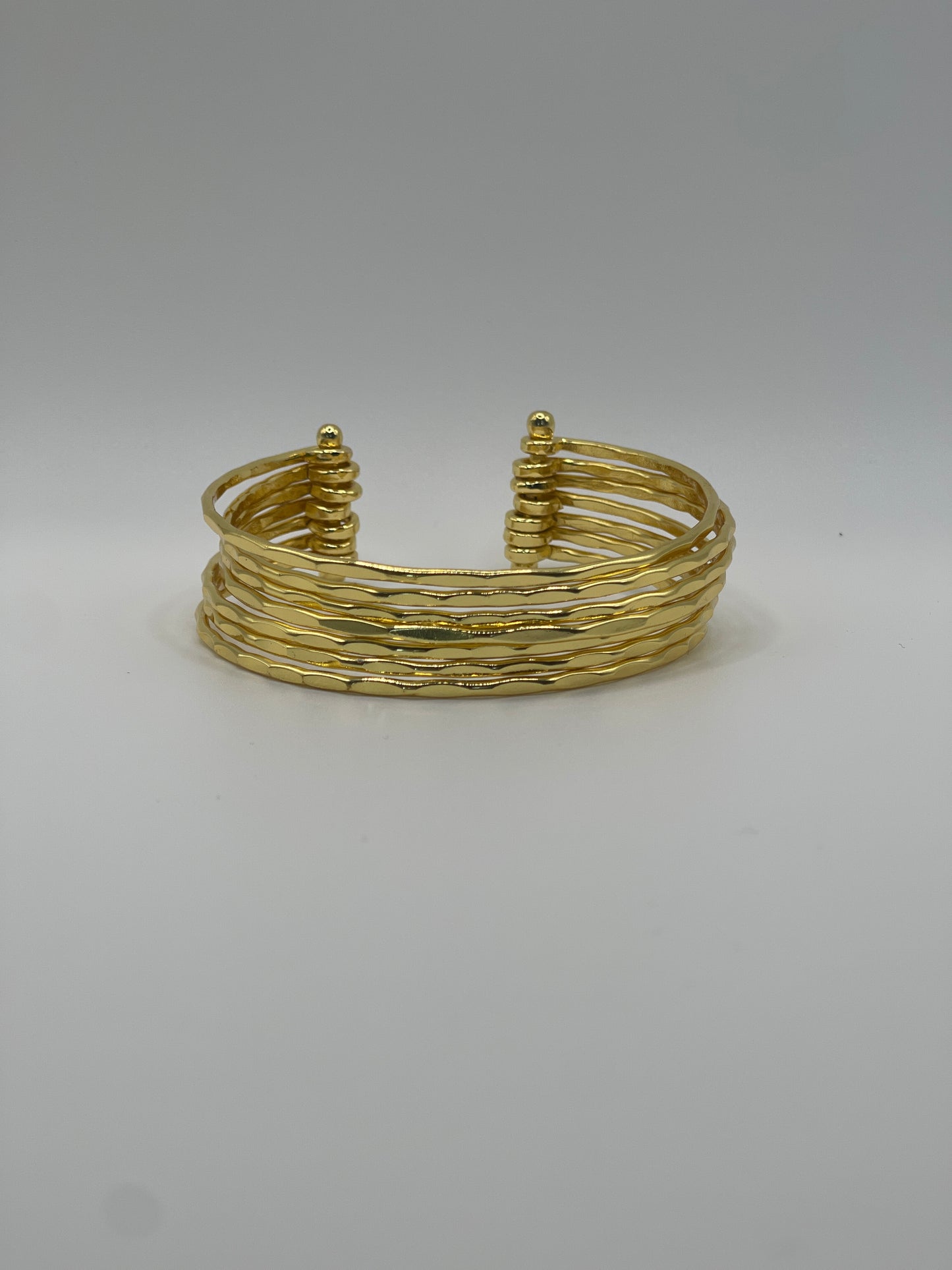 Astra Hammered Gold Cuff by Kalagaia, bold statement jewelry piece.